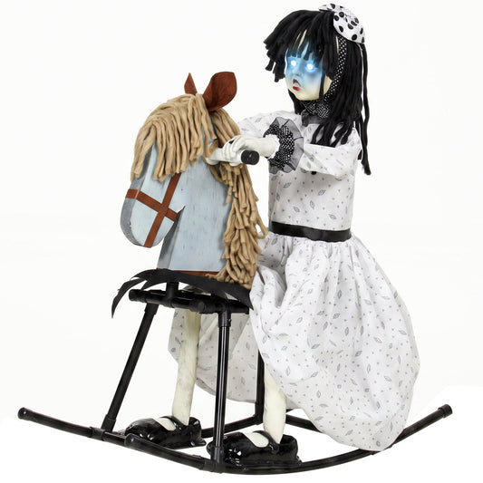 Animated Halloween girl on a rocking horse with glowing eyes, used as a haunted house prop