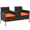 Brown rattan double garden chair with orange cushions and glass-top middle table with shelf