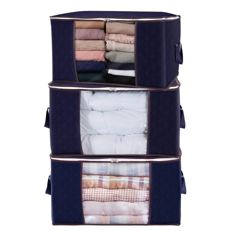 Stack of navy blue storage bags with clothes inside on a white background
