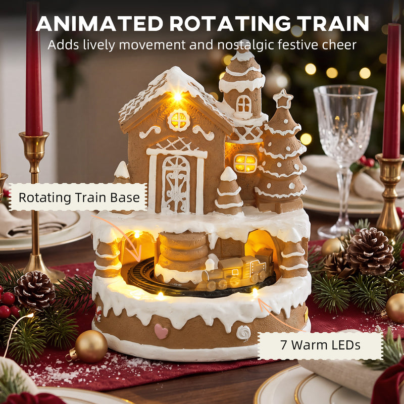 Close view of gingerbread house showing the rotating train base and warm white LED lights