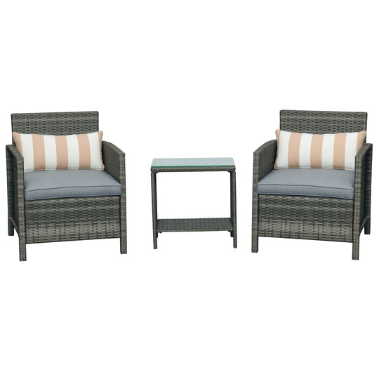 Grey rattan bistro set with two cushioned armchairs, striped bolsters and two-tier glass table
