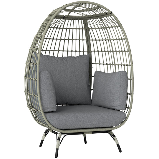 Charcoal grey freestanding rattan egg chair with light grey cushions and side pillows