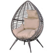 Grey rattan teardrop egg chair with full-body beige padded cushion on four slanted legs