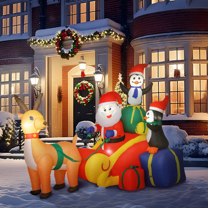 6ft Santa Sleigh and Penguin Christmas Inflatable in a festive outdoor setting