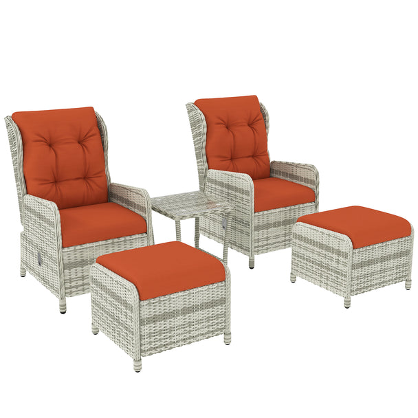 Rattan bistro set with two reclining chairs, footstools, orange cushions and glass table