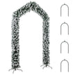 9ft snow-flocked Christmas tree arch framing a single front door