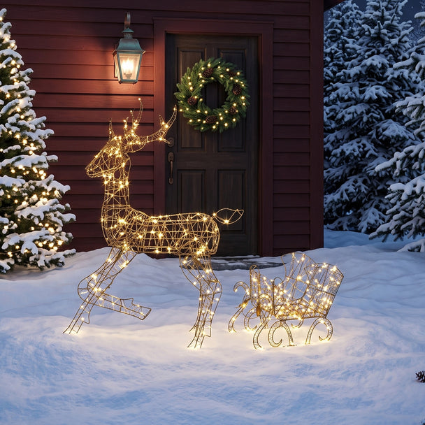 2-Piece Rattan Reindeer and Sleigh Christmas Light Set illuminated outside a decorated home