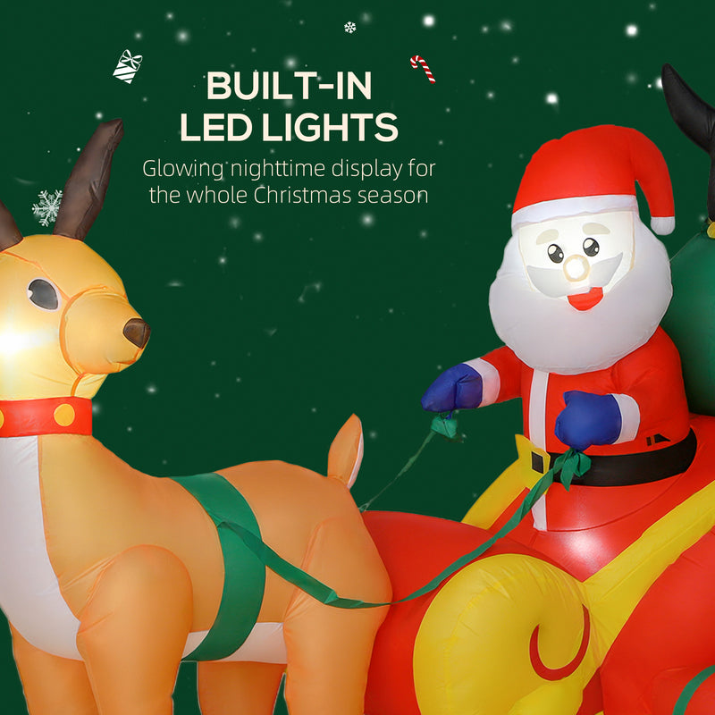 Illuminated 6ft Santa sleigh and penguin Christmas inflatable at night