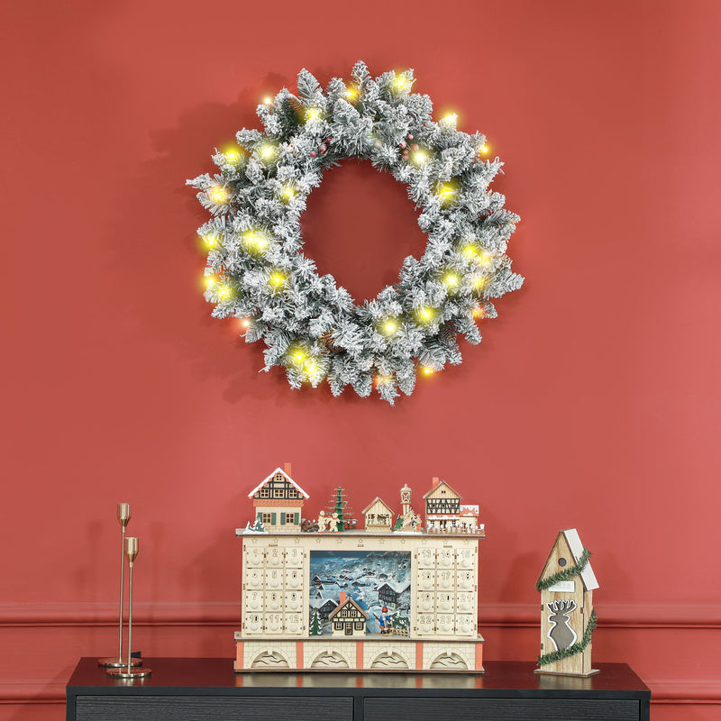 60cm Snowy Christmas Wreath hanging on display