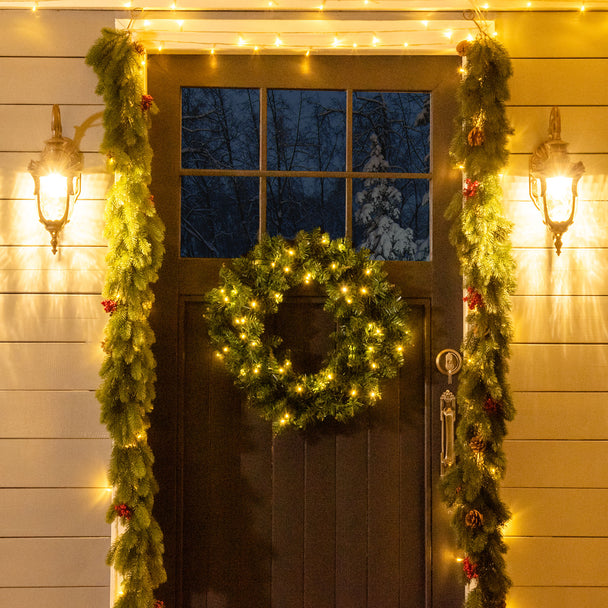 55cm Pre-Lit Christmas Wreath hanging in a festive room