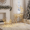 2-Piece Rattan Reindeer and Sleigh Christmas Light Set illuminated in a room