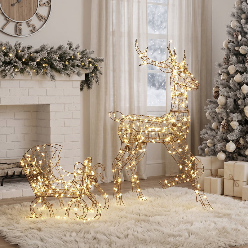 2-Piece Rattan Reindeer and Sleigh Christmas Light Set illuminated in a room