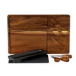 Acacia board with its recesses, slate, dish and knives laid beside