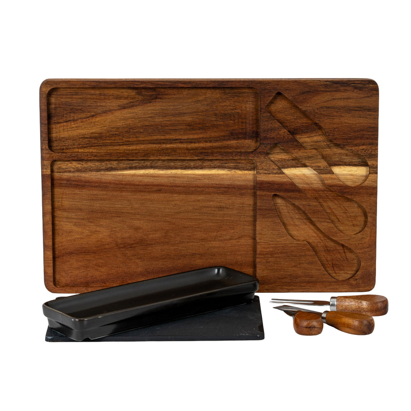 Acacia board with its recesses, slate, dish and knives laid beside