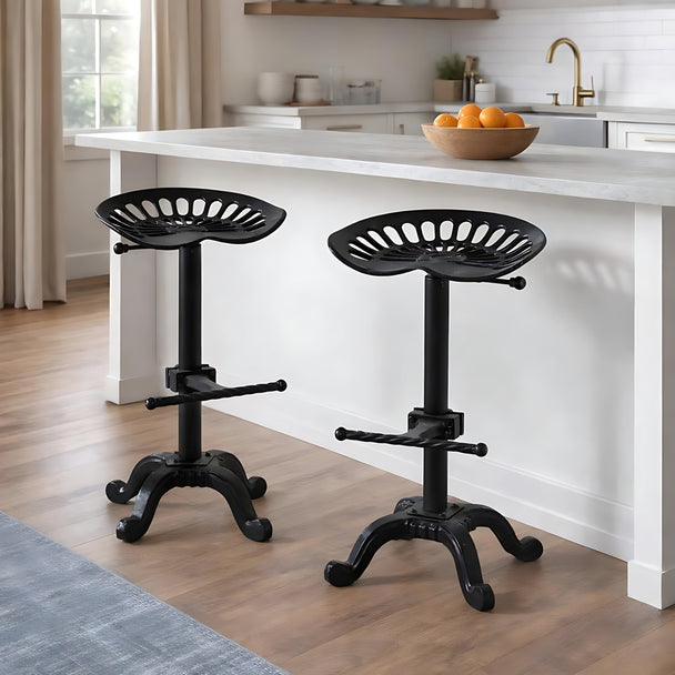 Two black tractor seat stools at a white kitchen island, sold individually