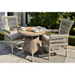 Amalfi bistro table with two woven chairs on a patio