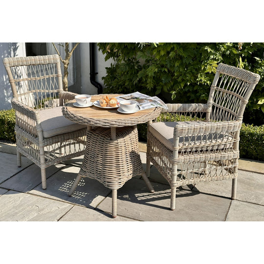 Amalfi bistro table with two woven chairs on a patio