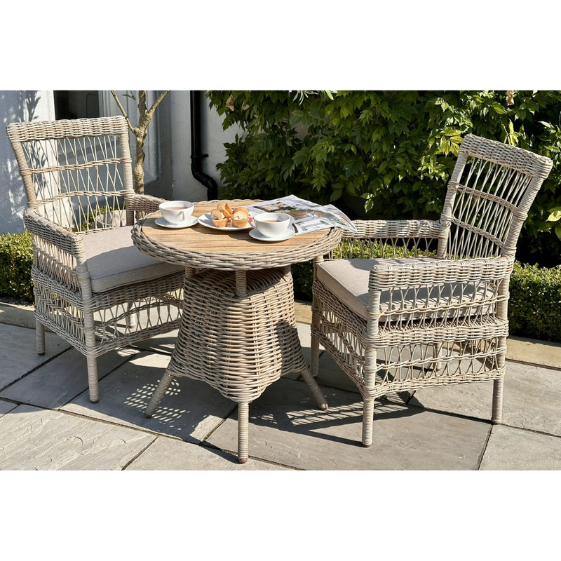 Amalfi bistro table with two woven chairs on a patio