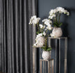 White orchids on metal display stands, shown with other orchids and stands sold separately