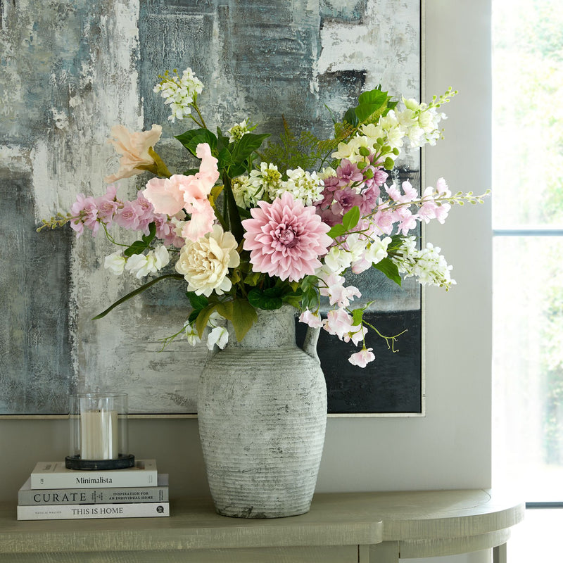 Athena amphora pot filled with flowers on a console
