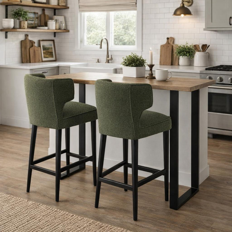 Two moss green bar stools at a kitchen island