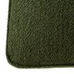 Close-up of the textured green fabric and piping