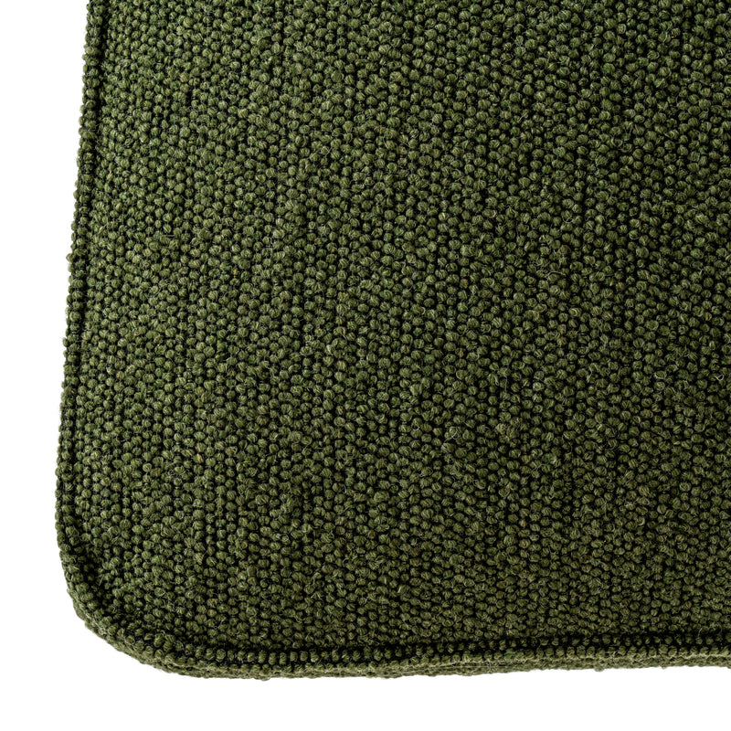 Close-up of the textured green fabric and piping