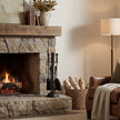 Black Fireside Companion Set with Duchess Top – 41cm, companion set beside a lit stone fireplace