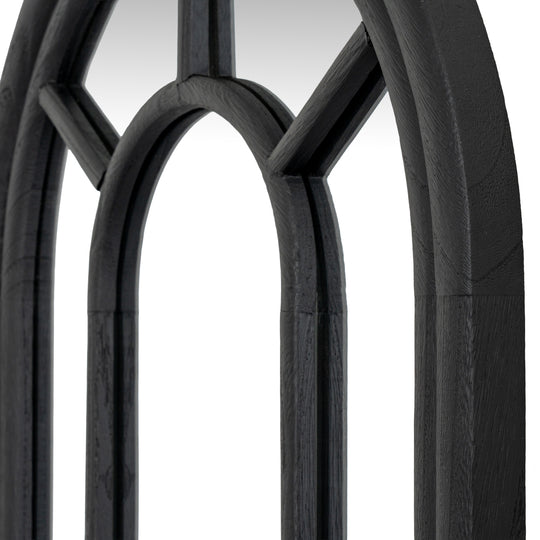 Close-up of the arched top and black wooden mullions