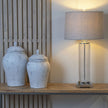 Two Bloomville ginger jars on a shelf beside a lamp, larger size sold separately