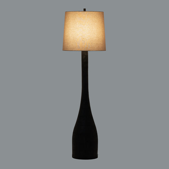 Brompton floor lamp switched on against a grey background