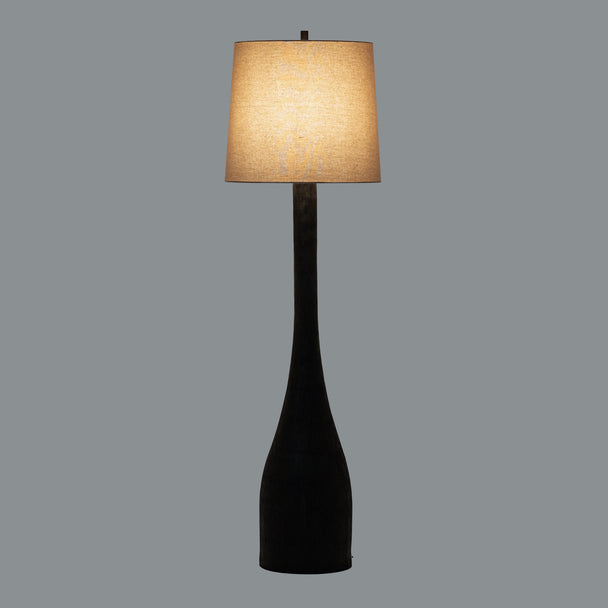 Brompton floor lamp switched on against a grey background