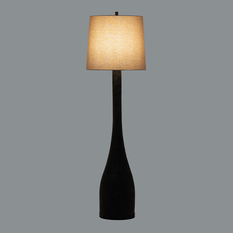 Brompton floor lamp switched on against a grey background