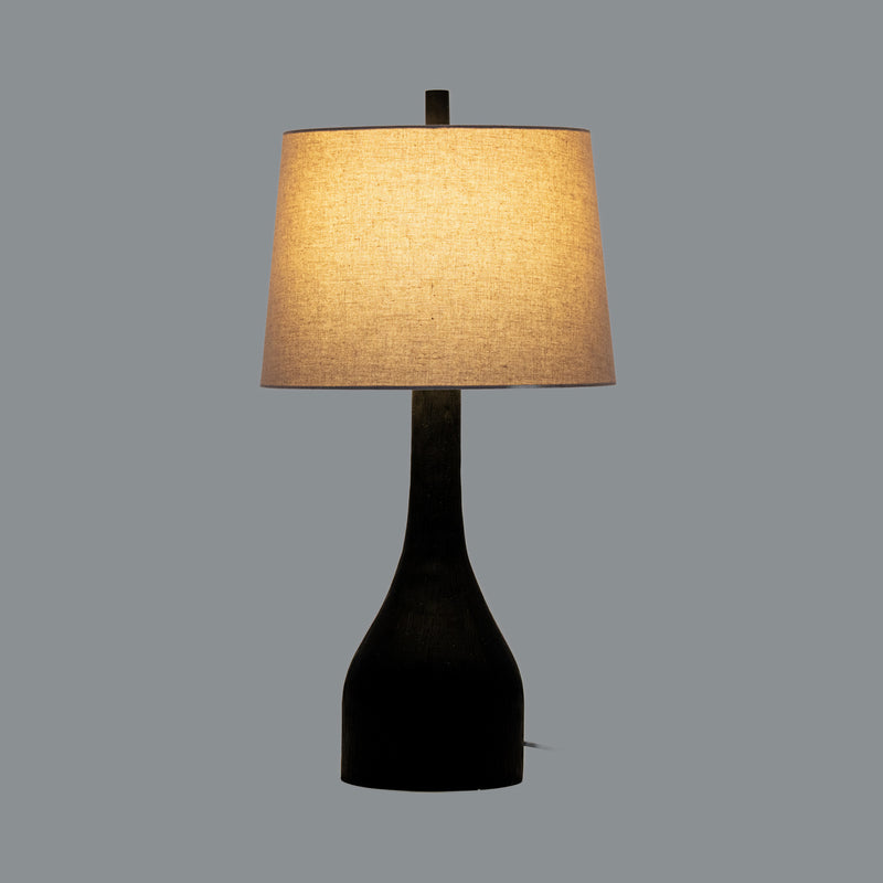 Brompton table lamp switched on against a grey background
