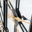 Angled view of the gold hands and black centre
