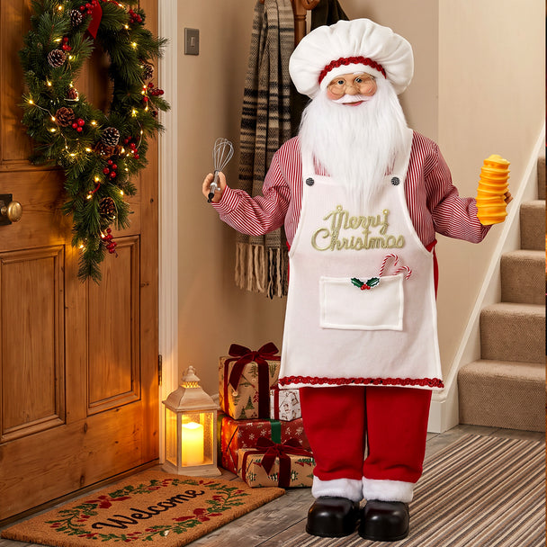 4ft Singing Chef Santa beside a decorated Christmas tree