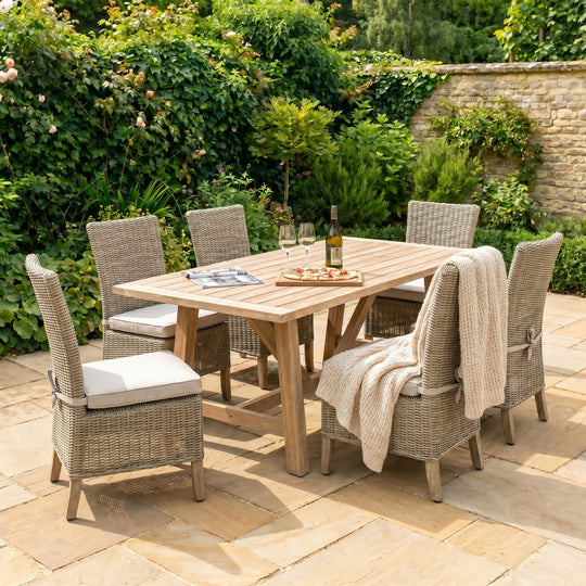 Capri wicker dining chairs around a wooden garden table