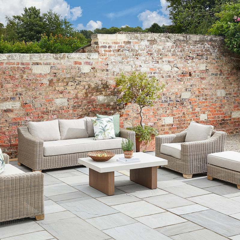 Capri armchair with a matching sofa on a walled patio, other pieces sold separately