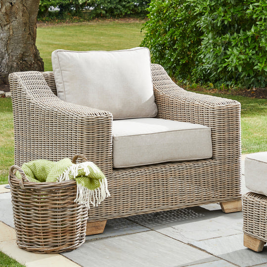 Capri wicker armchair on a garden terrace