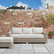 Capri sofa against a brick garden wall