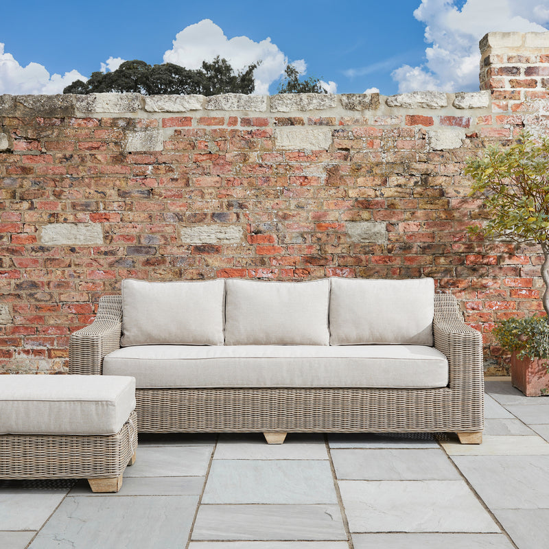 Capri sofa against a brick garden wall