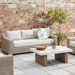 Capri wicker sofa on a patio with a coffee table, sold separately