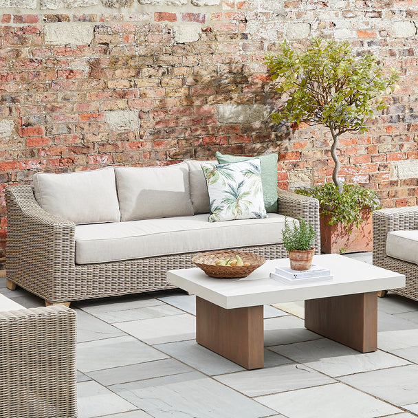 Capri wicker sofa on a patio with a coffee table, sold separately
