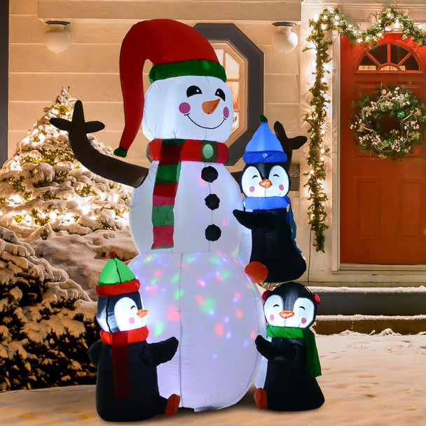 6ft Snowman and Three Penguins Christmas Inflatable displayed outside a decorated home