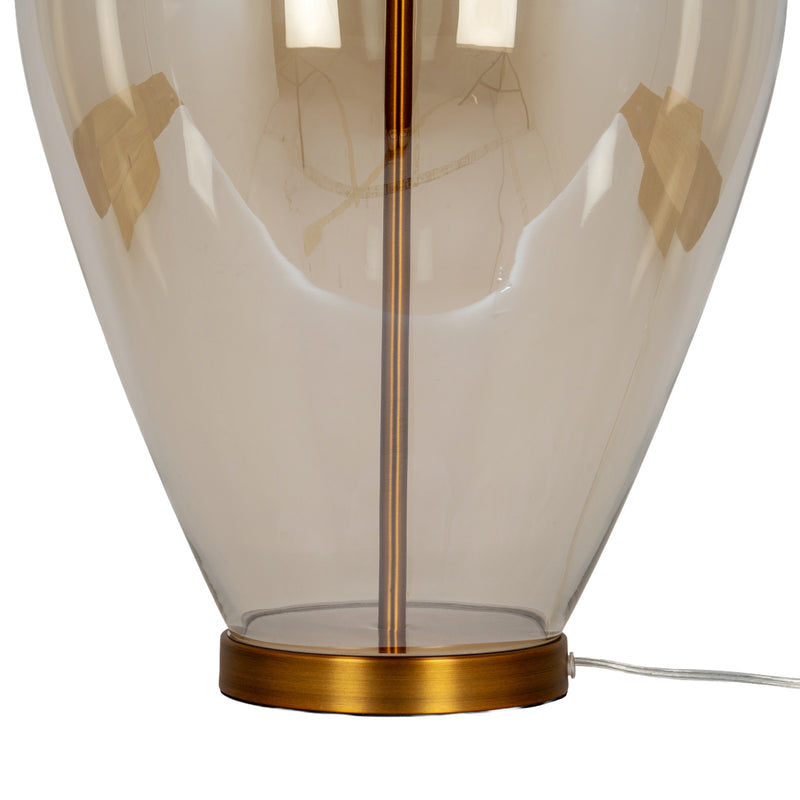 Gold-tone foot and cable at the base of the glass lamp