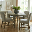 Cobham grey chairs around a round pedestal dining table