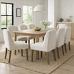 Compton cream boucle chairs around a wooden dining table