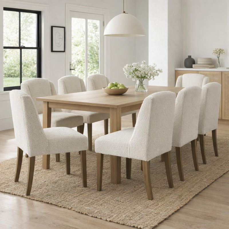 Compton cream boucle chairs around a wooden dining table