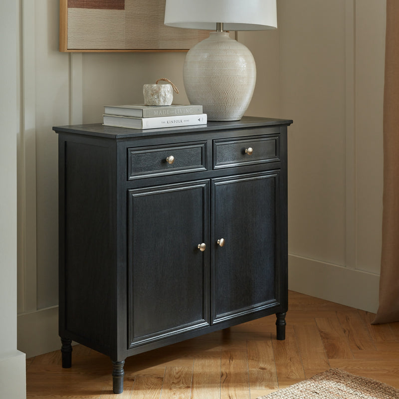 Contour black sideboard in a hallway with a lamp