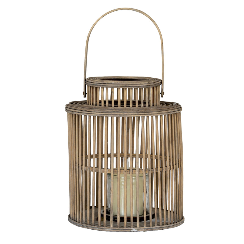 Cylinder wicker lantern with a candle in its glass holder